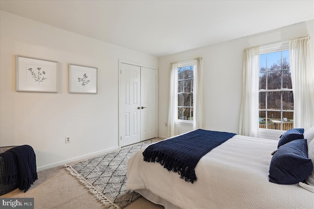 carpeted bedroom with a closet