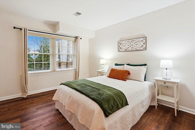 bedroom featuring dark hardwood / wood-style flooring