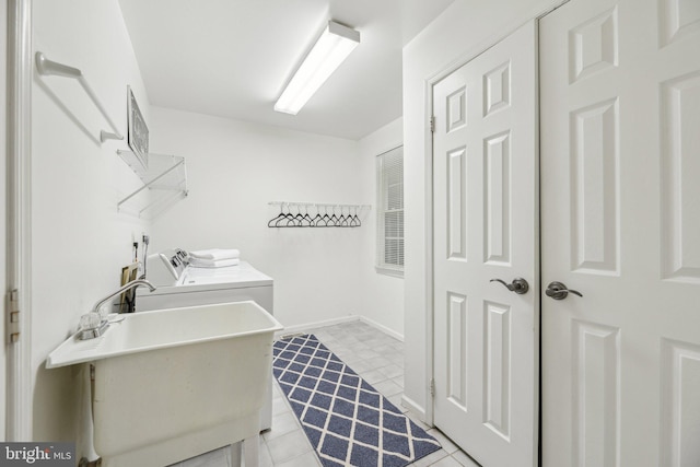 laundry area featuring sink and washing machine and clothes dryer