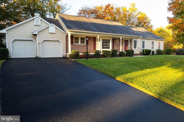 ranch-style house with a garage and a front lawn