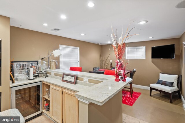 kitchen with wine cooler and light brown cabinets