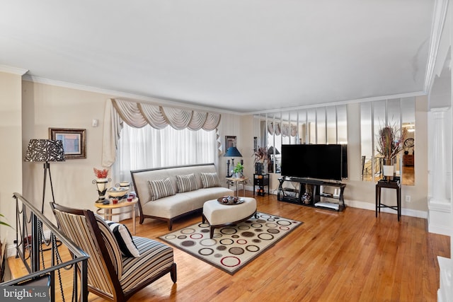 living room with ornamental molding, wood-type flooring, and ornate columns