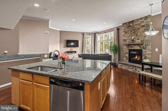 kitchen with a fireplace, sink, ornamental molding, a kitchen island with sink, and stainless steel dishwasher