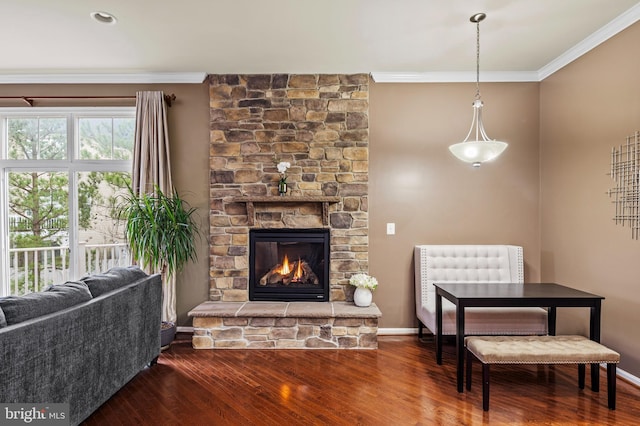 interior space featuring hardwood / wood-style flooring, a fireplace, and crown molding