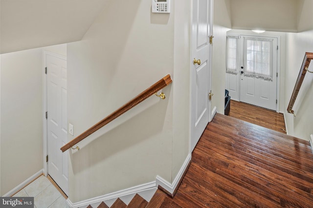 stairway with hardwood / wood-style flooring