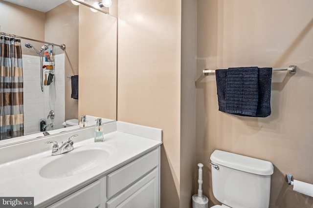 bathroom with vanity, curtained shower, and toilet