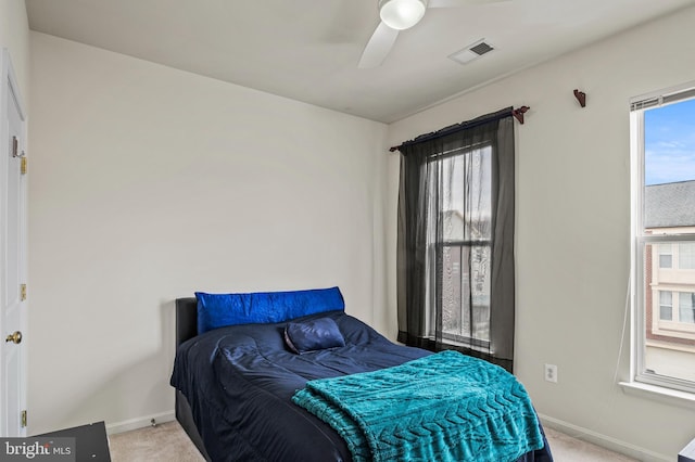 bedroom with light carpet and ceiling fan