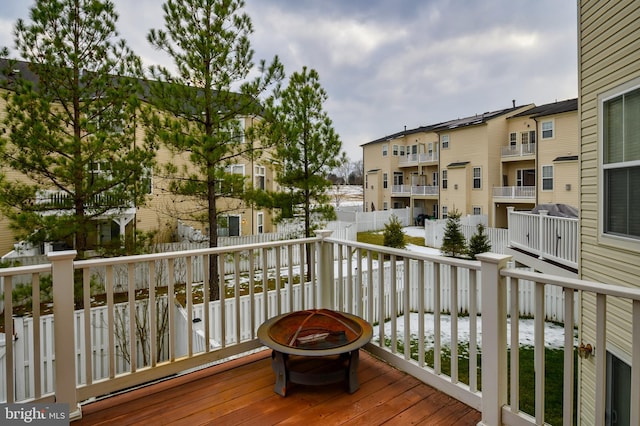 wooden terrace featuring a fire pit