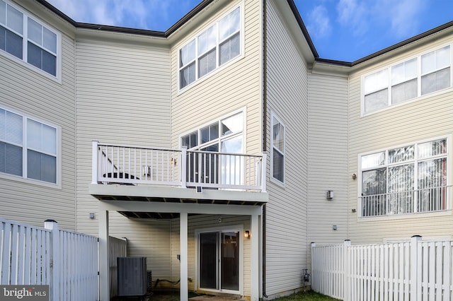 rear view of property with cooling unit