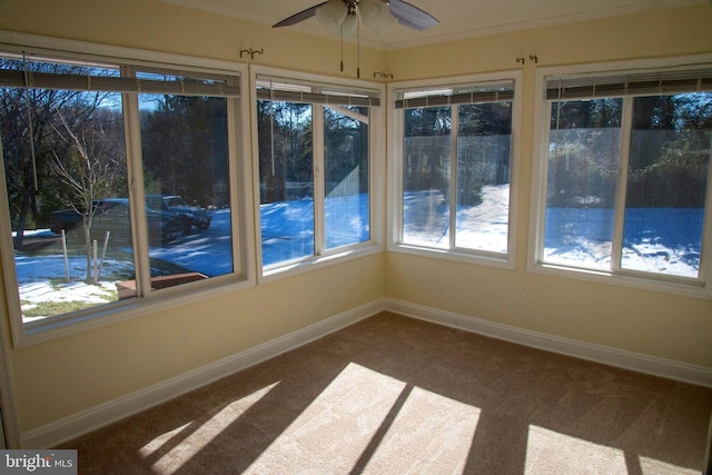 unfurnished sunroom with ceiling fan