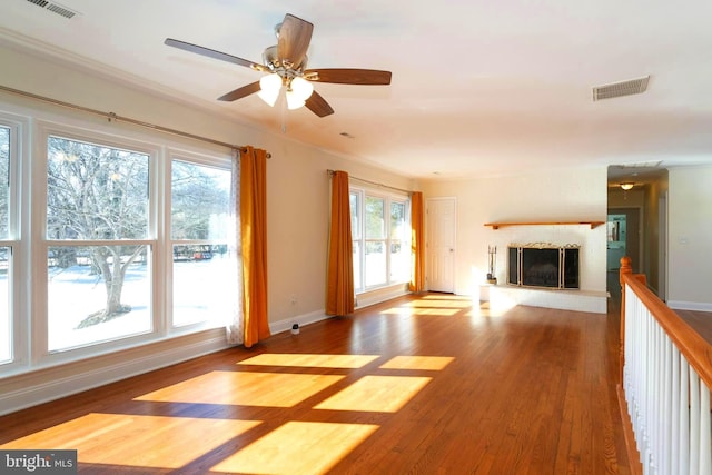 unfurnished living room featuring hardwood / wood-style flooring and a wealth of natural light