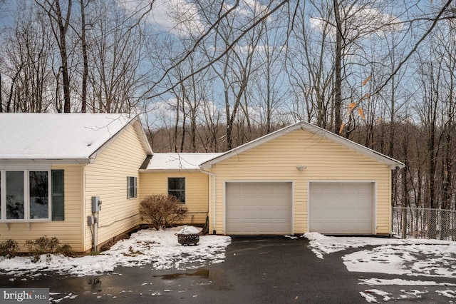 view of snow covered exterior featuring a garage