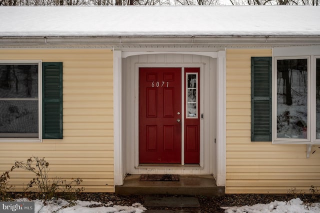 view of snow covered property entrance