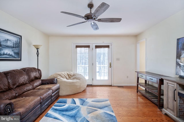 living room featuring ceiling fan and light wood-type flooring