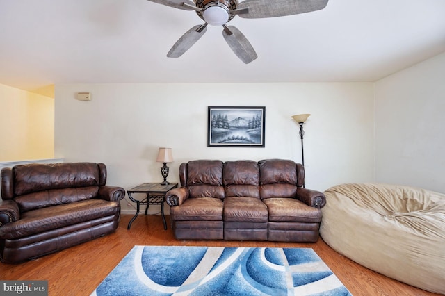 living room with hardwood / wood-style flooring and ceiling fan