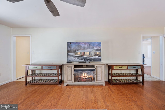 living room featuring ceiling fan and light hardwood / wood-style floors