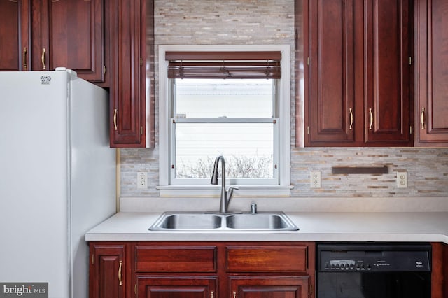 kitchen with white fridge, black dishwasher, sink, and decorative backsplash