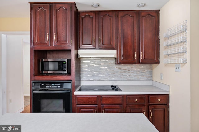 kitchen with tasteful backsplash and black appliances