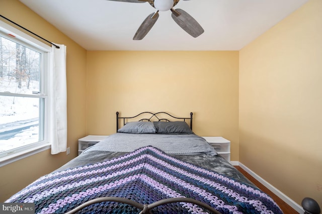 bedroom with multiple windows and ceiling fan