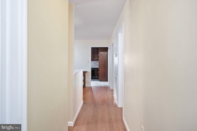 hall with light hardwood / wood-style floors