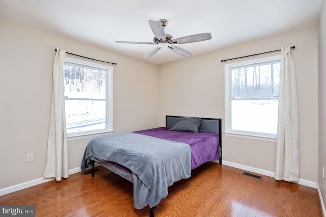 bedroom with hardwood / wood-style flooring and ceiling fan