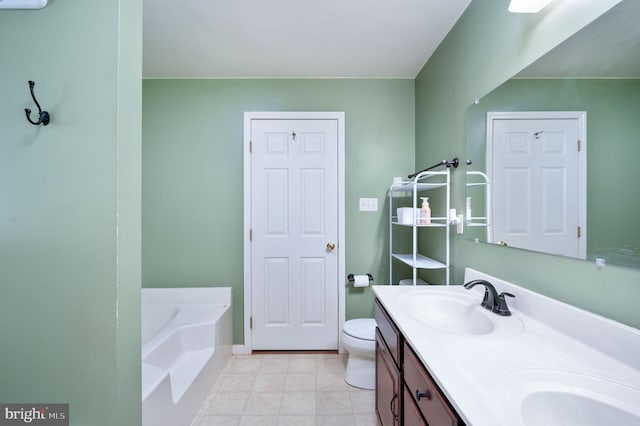 bathroom featuring vanity, a bathtub, and toilet