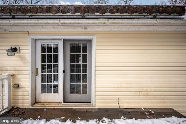 view of snow covered property entrance