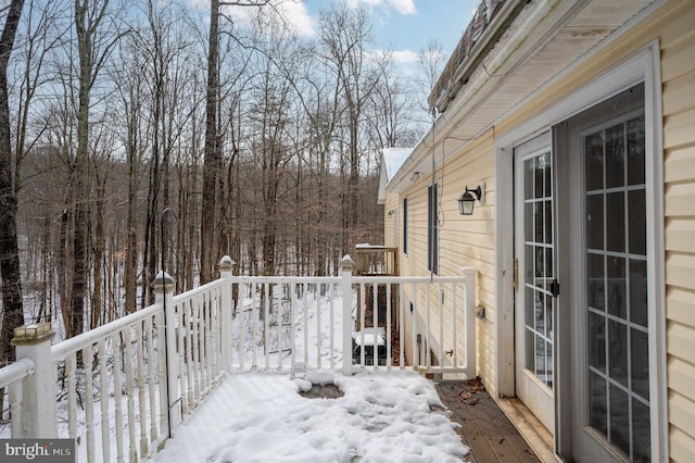 view of snow covered back of property