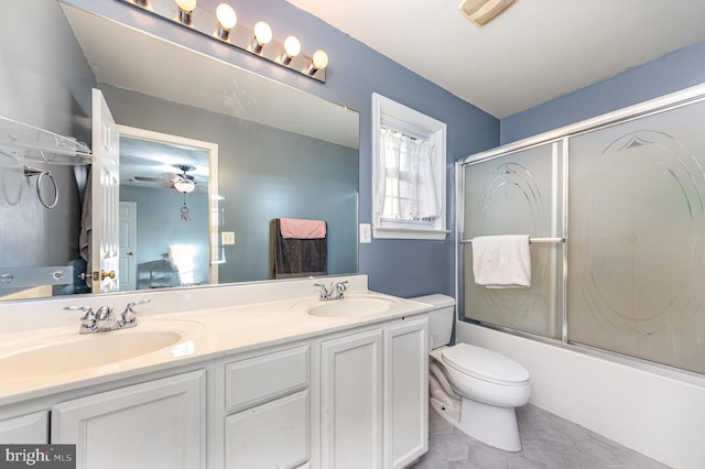 full bathroom with vanity, toilet, and combined bath / shower with glass door