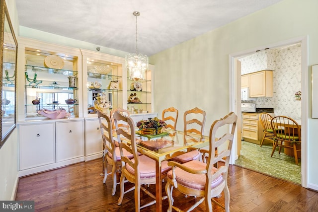 dining room featuring an inviting chandelier and wood-type flooring