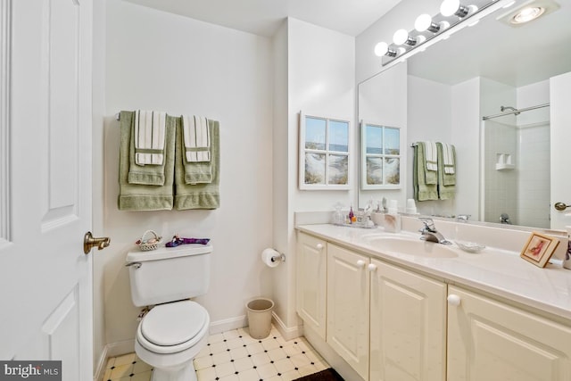 bathroom featuring vanity, a shower, and toilet