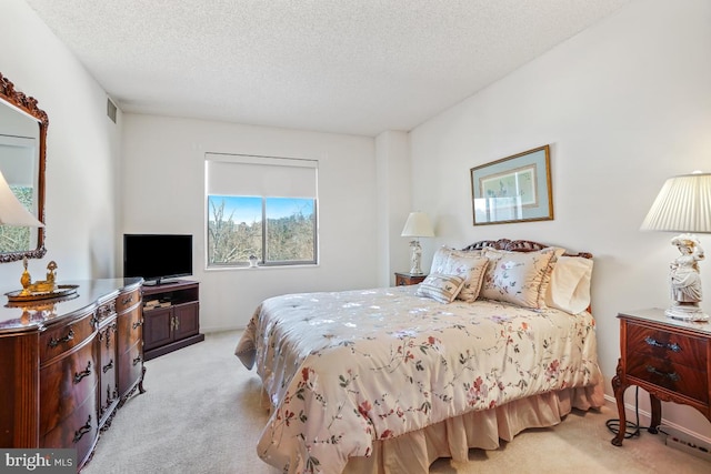 carpeted bedroom with a textured ceiling