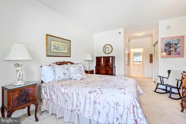 carpeted bedroom with ensuite bath