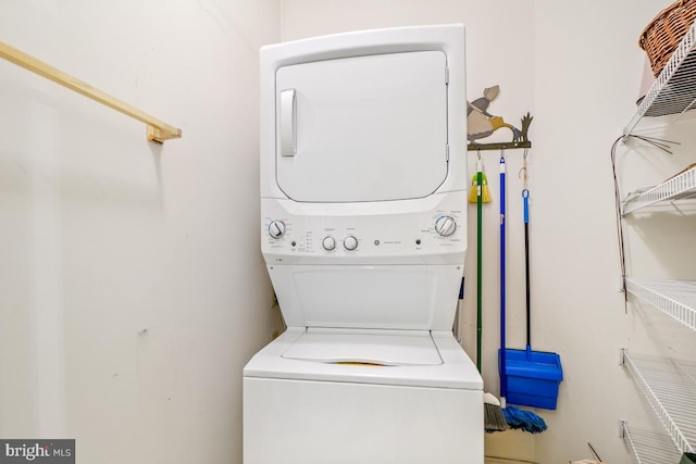 washroom featuring stacked washer and clothes dryer