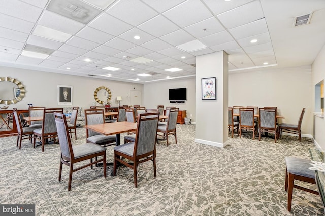 dining room with a paneled ceiling and carpet flooring