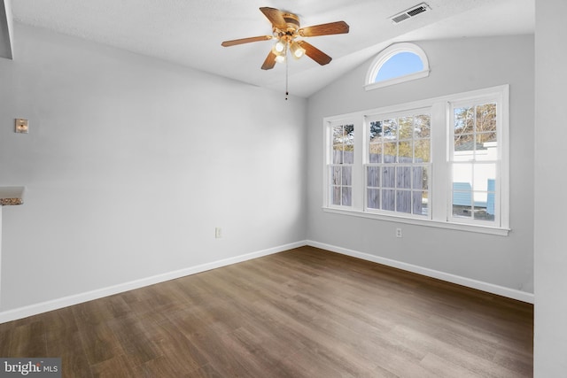 spare room featuring ceiling fan, wood-type flooring, and vaulted ceiling