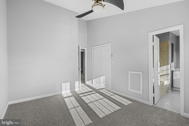 carpeted spare room with ceiling fan