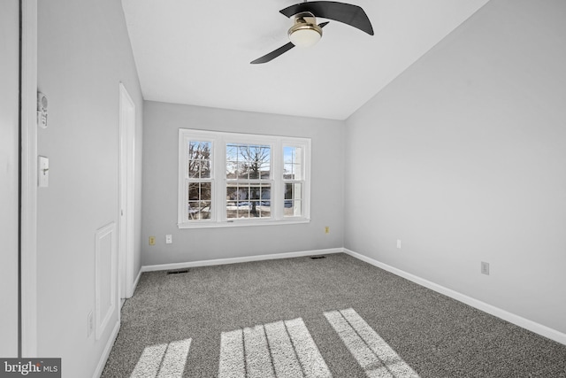 carpeted empty room with lofted ceiling and ceiling fan