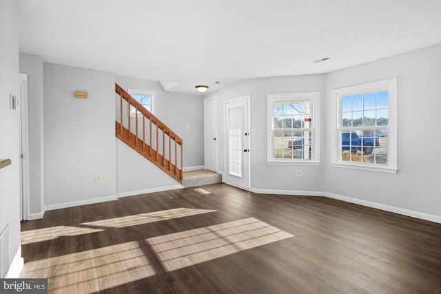 foyer with dark hardwood / wood-style floors and a textured ceiling