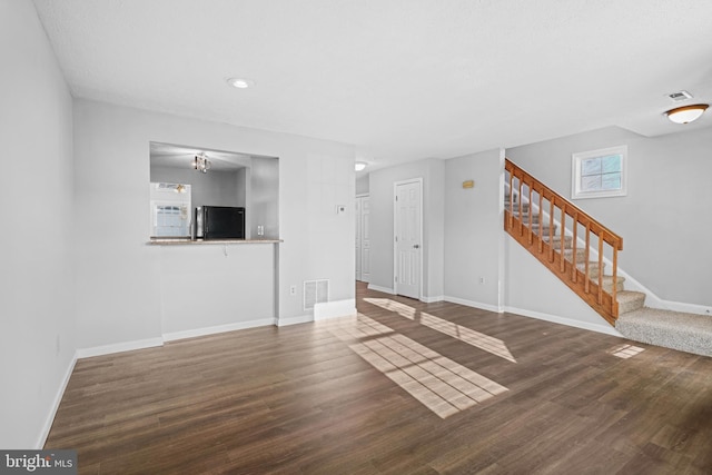 unfurnished living room featuring hardwood / wood-style floors