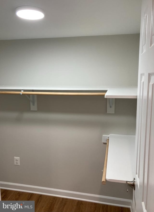 walk in closet featuring dark wood-type flooring