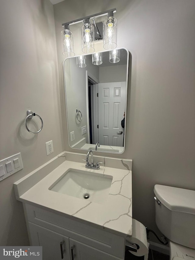 bathroom with toilet and vanity