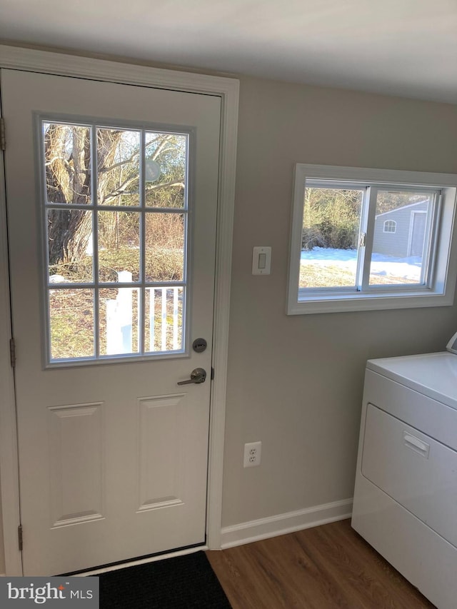 entryway featuring dark hardwood / wood-style flooring, plenty of natural light, and washer / dryer