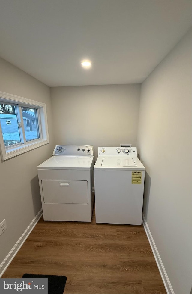 laundry area with washing machine and dryer and dark wood-type flooring