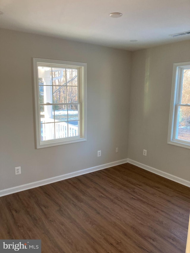 unfurnished room featuring dark hardwood / wood-style floors