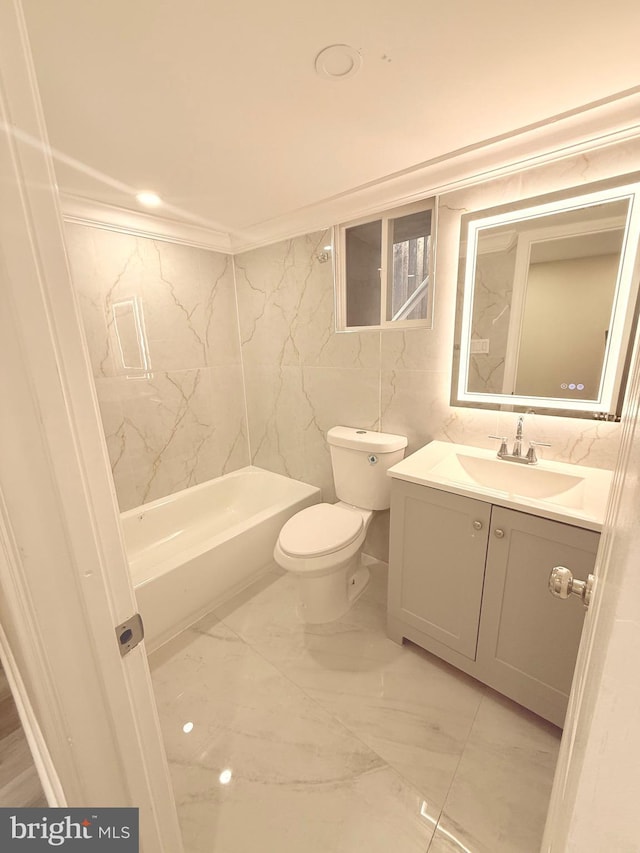 full bathroom featuring toilet, vanity, tile walls, crown molding, and shower / bath combination