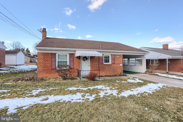 view of front of property with a yard and a carport