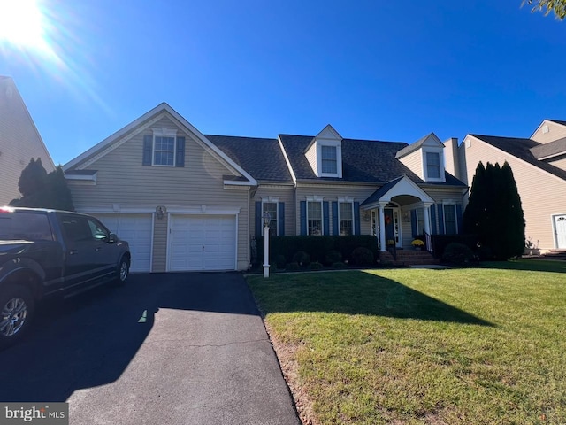 view of front of house featuring a garage and a front lawn