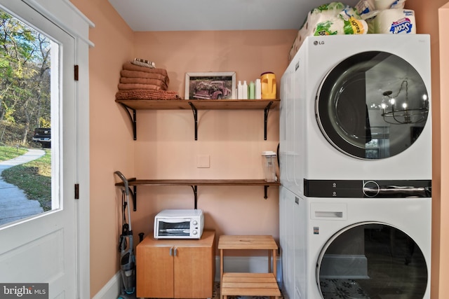 washroom with stacked washer / drying machine