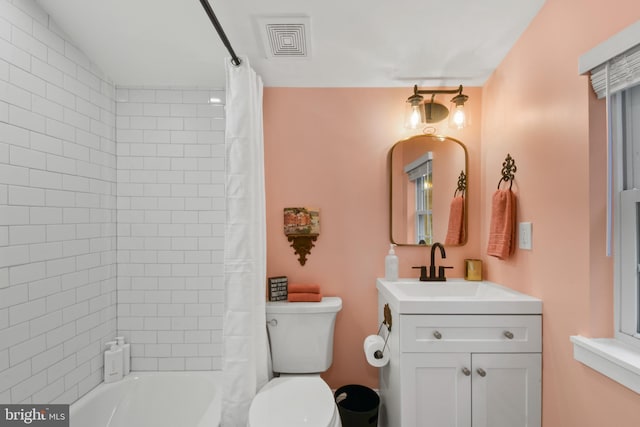 full bathroom with vanity, shower / bath combination with curtain, and toilet